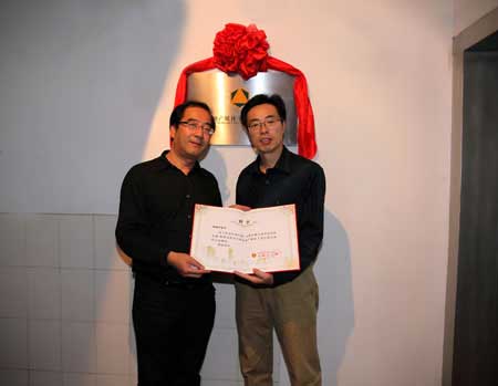 刘然副总编辑（左）代表刘延申教授接受王慧敏主任（右）颁发的总顾问聘书